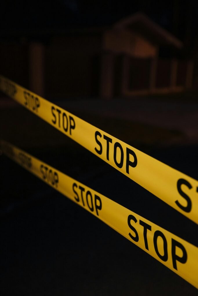pexels-photo-10481285-10481285 Yellow stop tape in a night crime scene setup, creating a tense atmosphere.